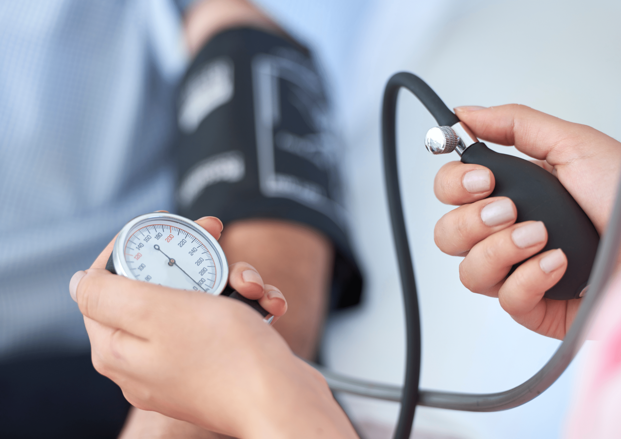 Close-up of doctor taking blood pressure of a patient to measure heart rate.
